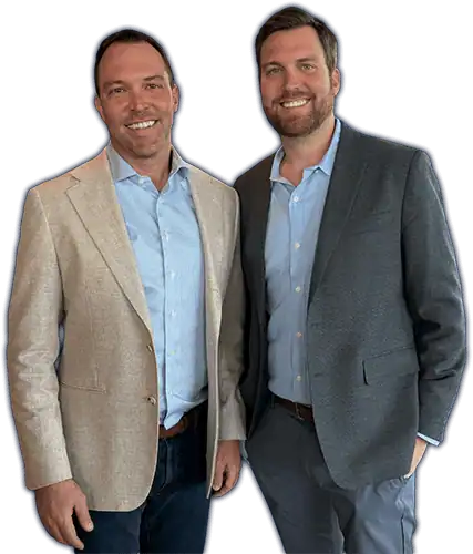 Two professional personal injury lawyers in suits smiling, standing together.
